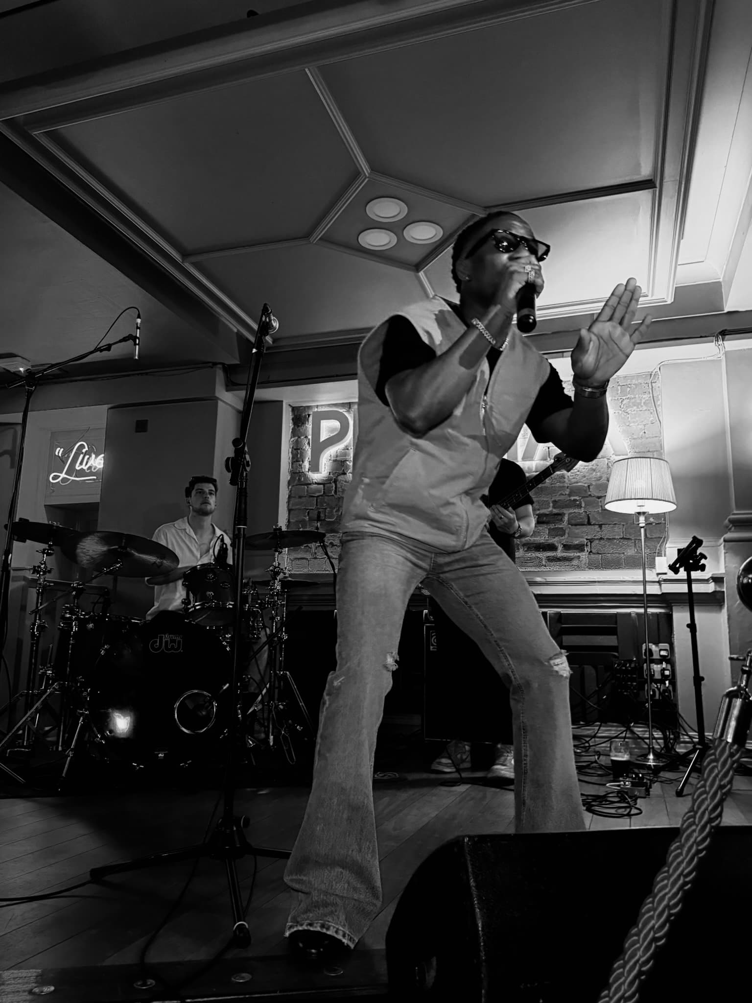Tiyo Kay on stage in black and white